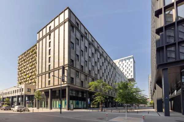Architekturfotografie der markanten Außenfassade und des Empfangsbereichs der Adina Serviced Apartments Wien